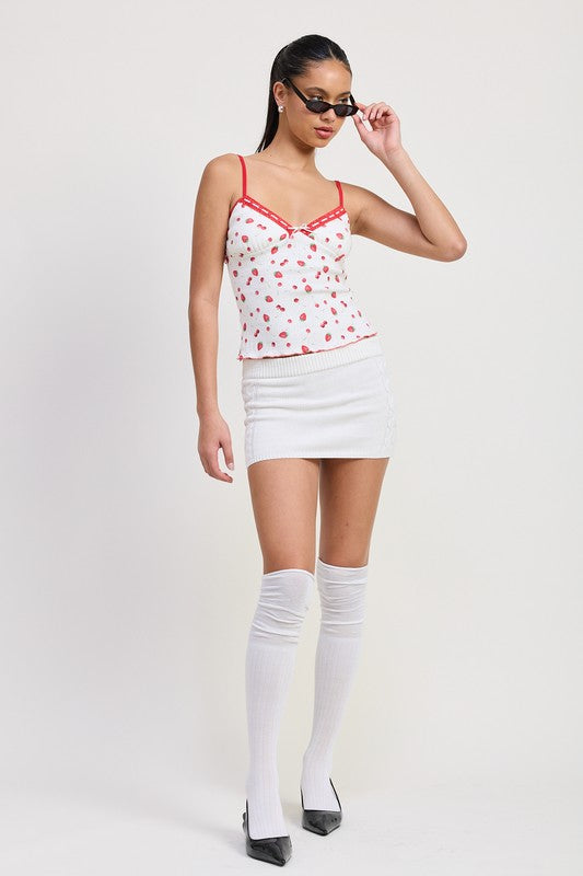 Emory Park Printed Jersey Cami Top with red floral print and red trim styled with white mini skirt and thigh-high socks
