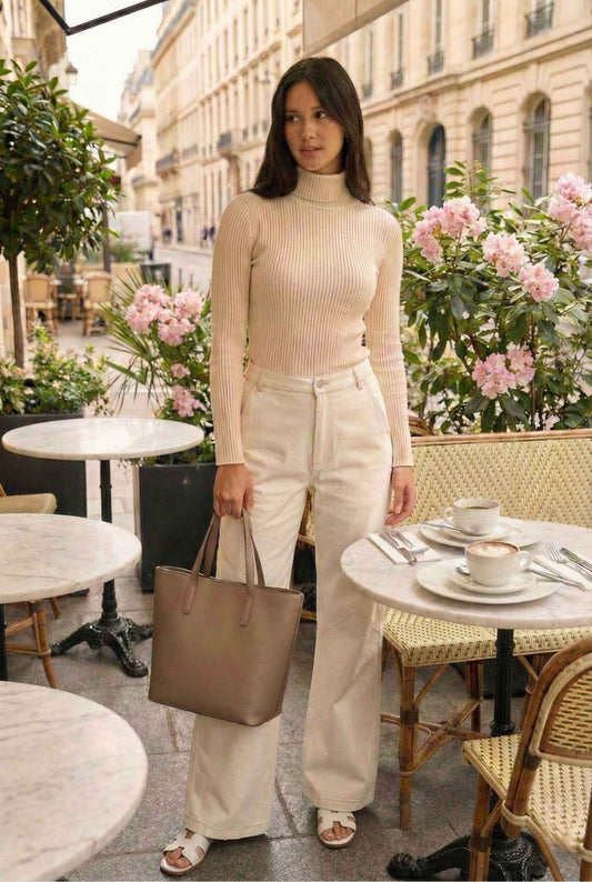 Model wearing Bianca Pants in Off White Cotton-Stretch Seamed Wide-Leg Trousers with ribbed turtleneck and sandals standing on luxury brunch patio