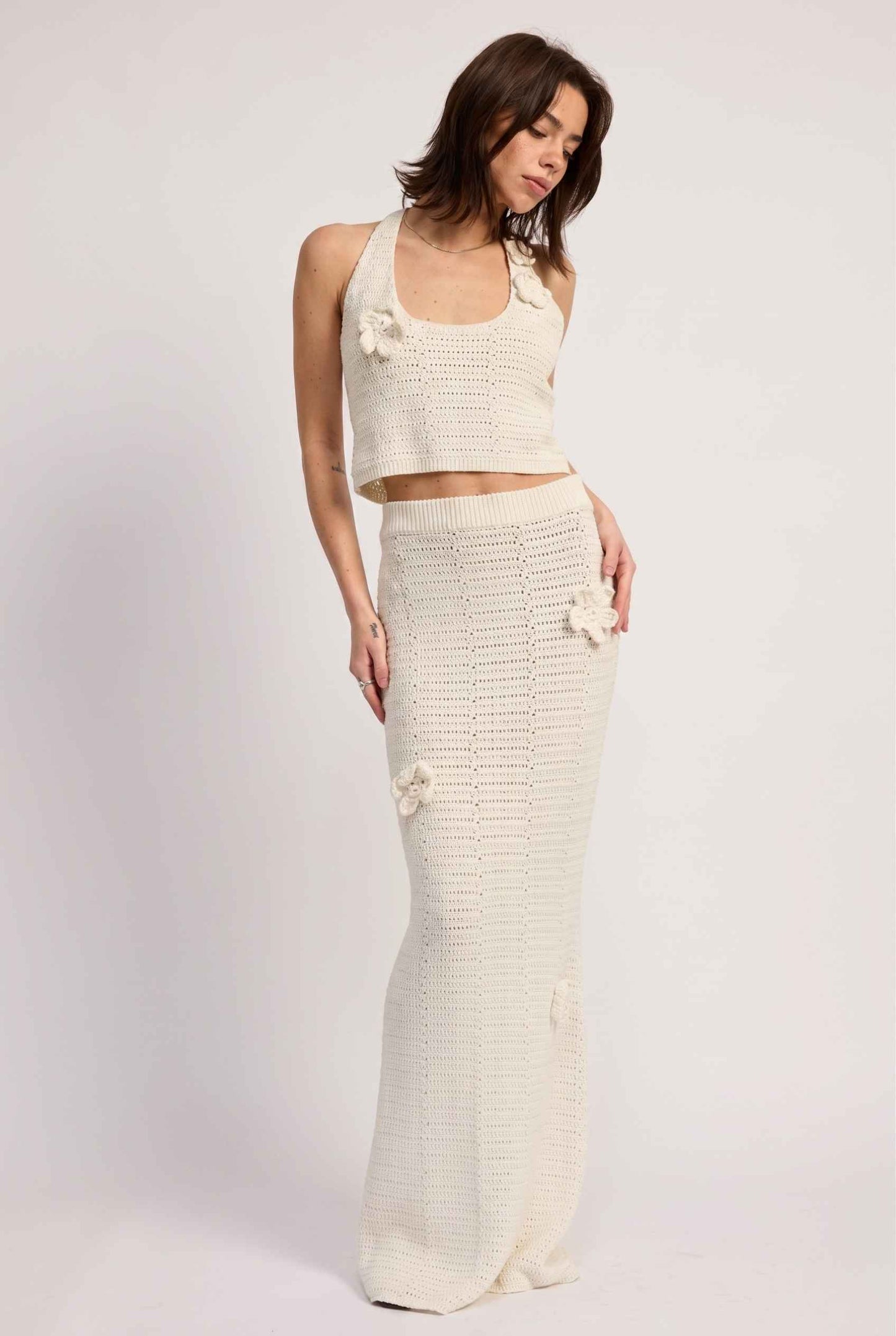 Model wearing Capri Floral Crochet Halter Top in Ivory Cotton Knit Crop Top with matching maxi skirt