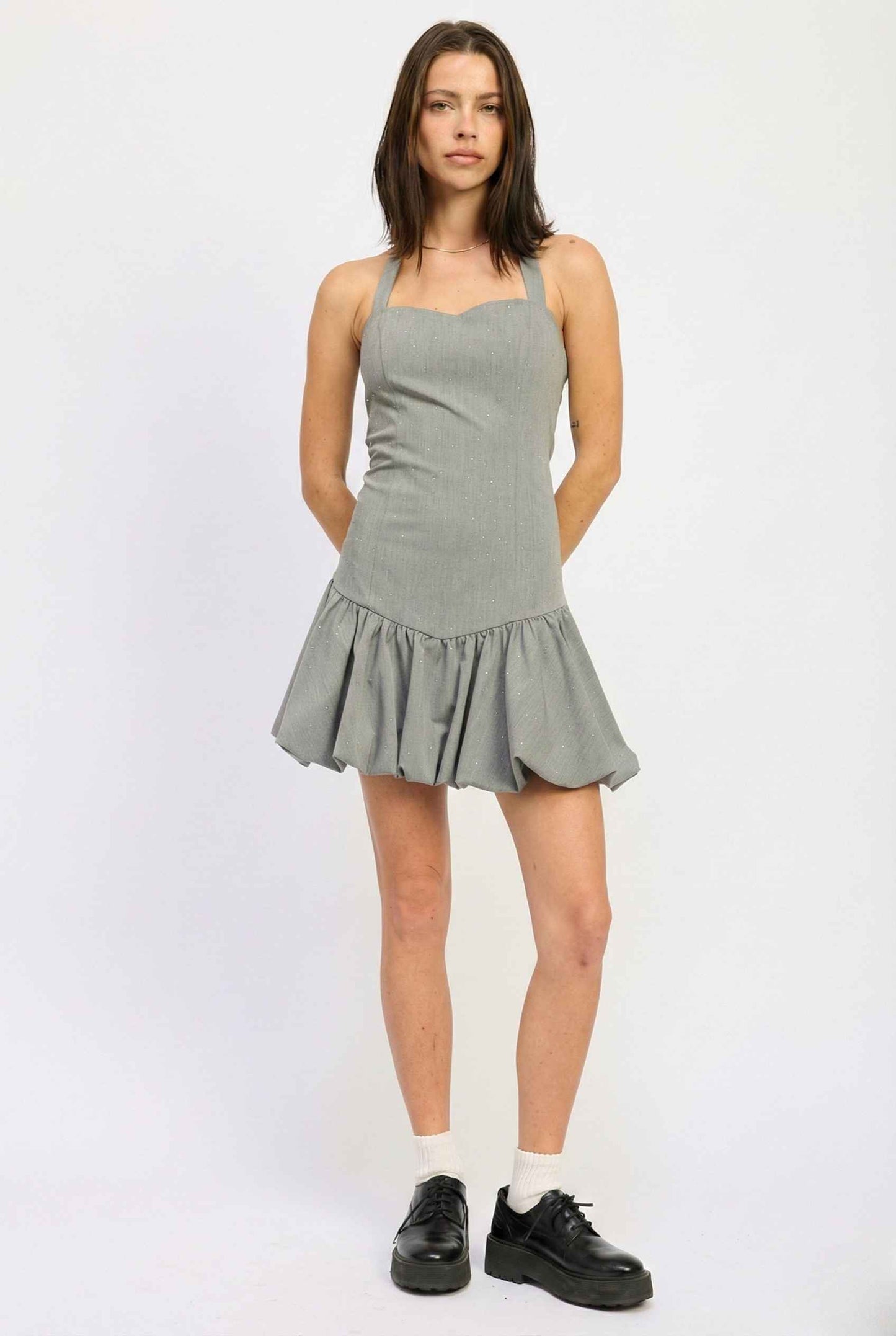 Woman wearing a Colette Mini Grey Rhinestone Drop-Waist Bubble Dress on a white background
