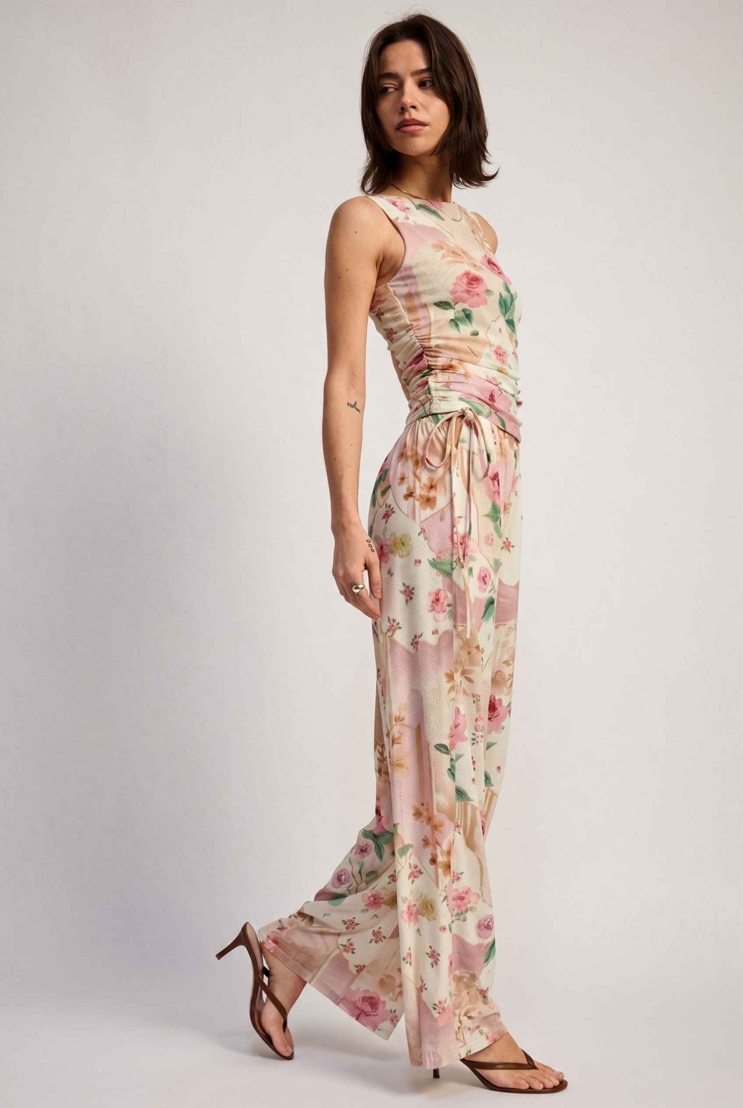 Model wearing Isabella Ruched Floral Tank in Rose Floral Sleeveless Mesh Top paired with matching bottoms and heeled sandals