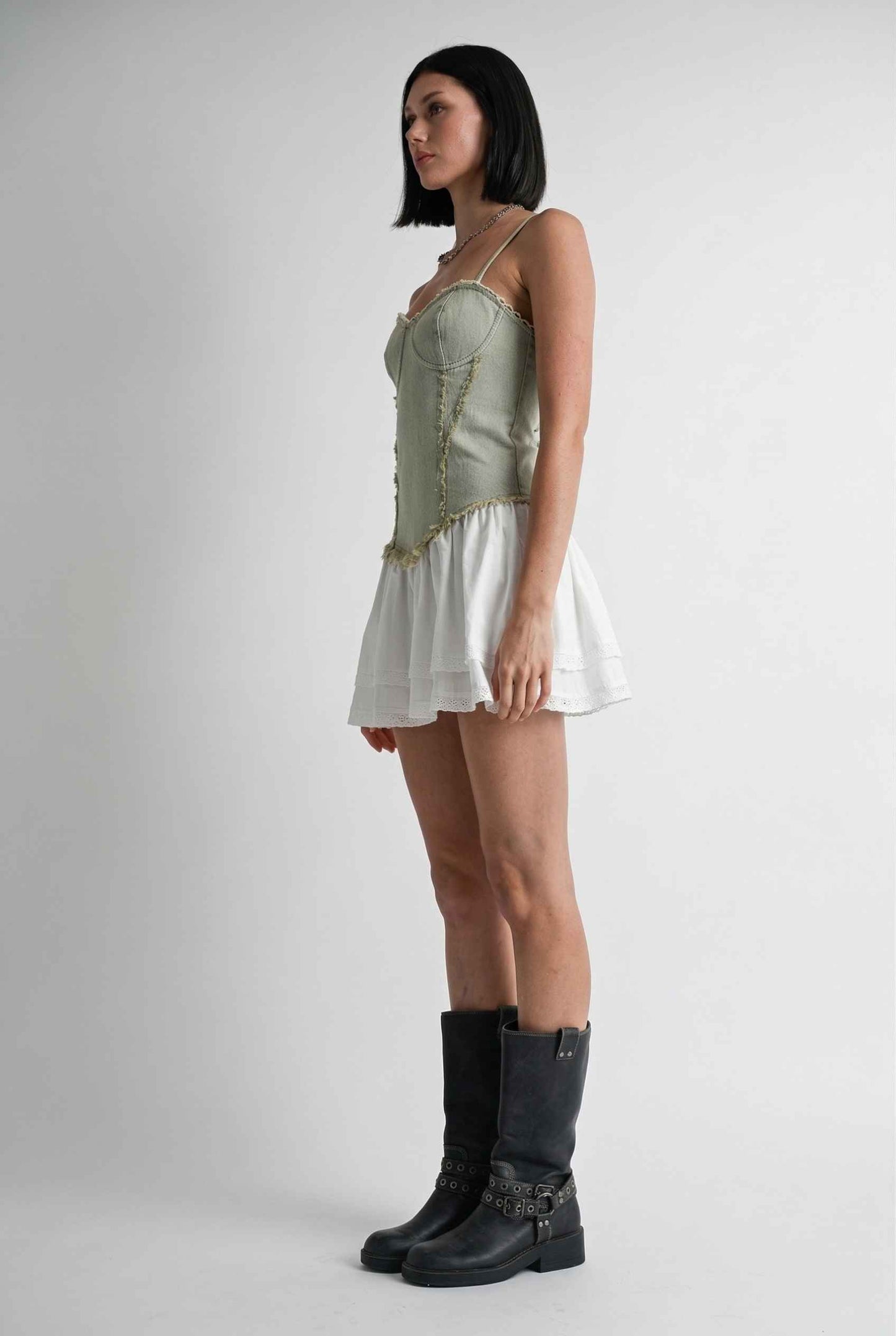 Model wearing Willow Mini in Light Green Denim with cotton tiers dress paired with combat boots