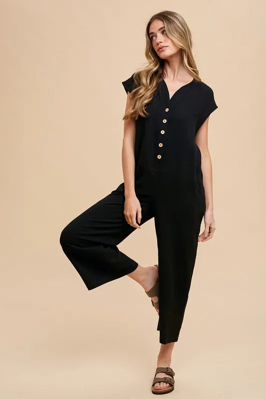 Annie Wear Button Detail Wide Leg Jumpsuit with Pockets in black, featuring a stylish button front and relaxed fit