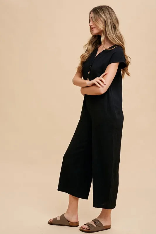 Annie Wear Button Detail Wide Leg Jumpsuit with Pockets in black, featuring a stylish design and comfortable fit