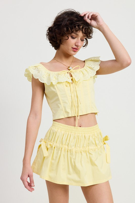 Emory Park Mini Ruched Poplin Mini Skirt in yellow with ruched details and side bows worn by model