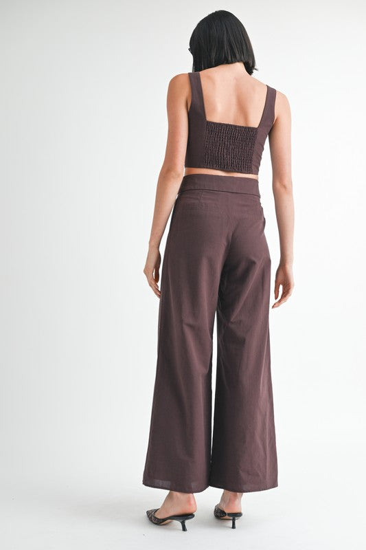 Emory Park Button Up Cropped Top With Shoulder Ties in dark brown shown from back on model