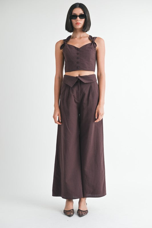 Emory Park Button Up Cropped Top With Shoulder Ties in dark brown worn with matching wide-leg pants