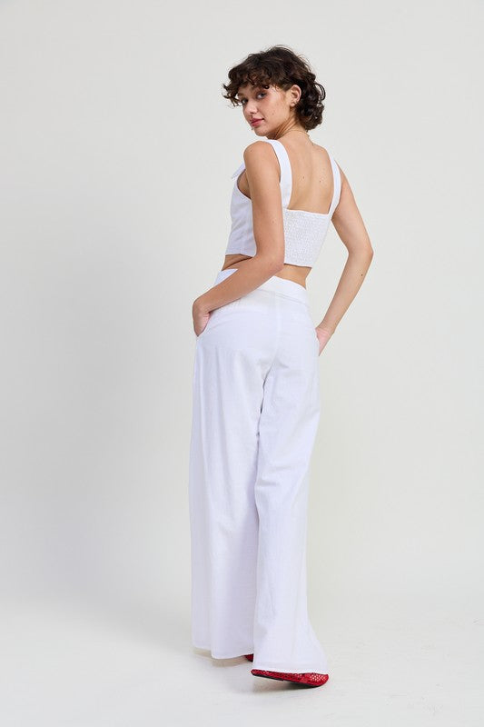Emory Park Button Up Cropped Top With Shoulder Ties worn by model paired with white wide-leg pants