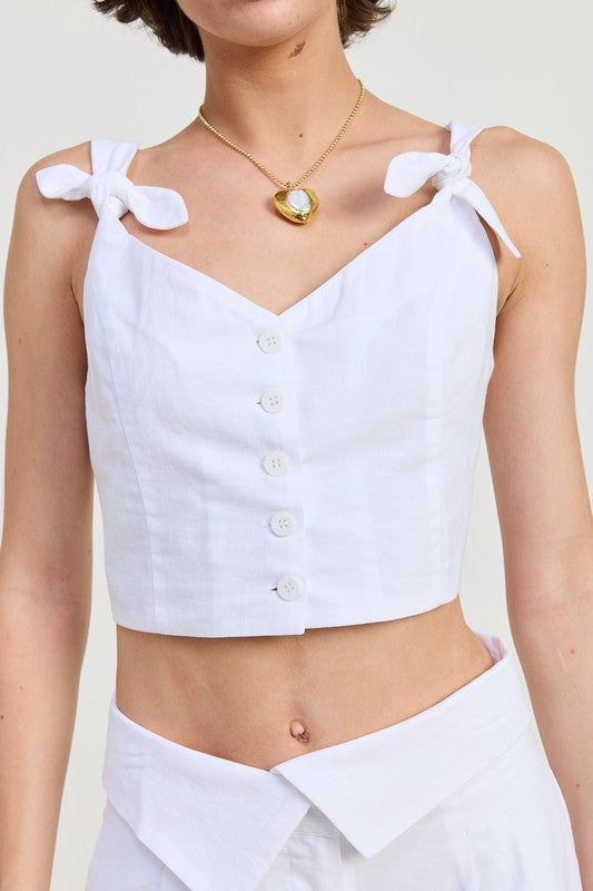 Emory Park Button Up Cropped Top With Shoulder Ties in white linen fabric with front buttons and tied shoulder straps