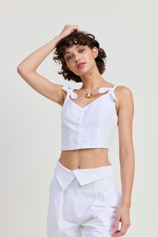 Emory Park Button Up Cropped Top With Shoulder Ties in white worn by model with matching white pants