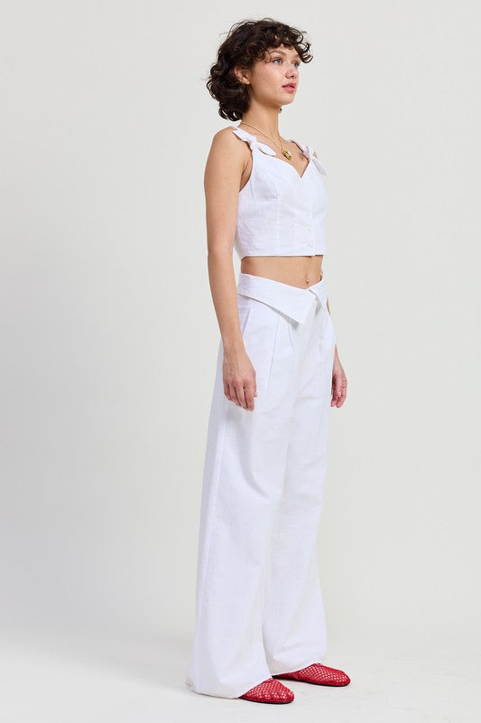 Emory Park Button Up Cropped Top With Shoulder Ties in white worn with high waist wide leg pants