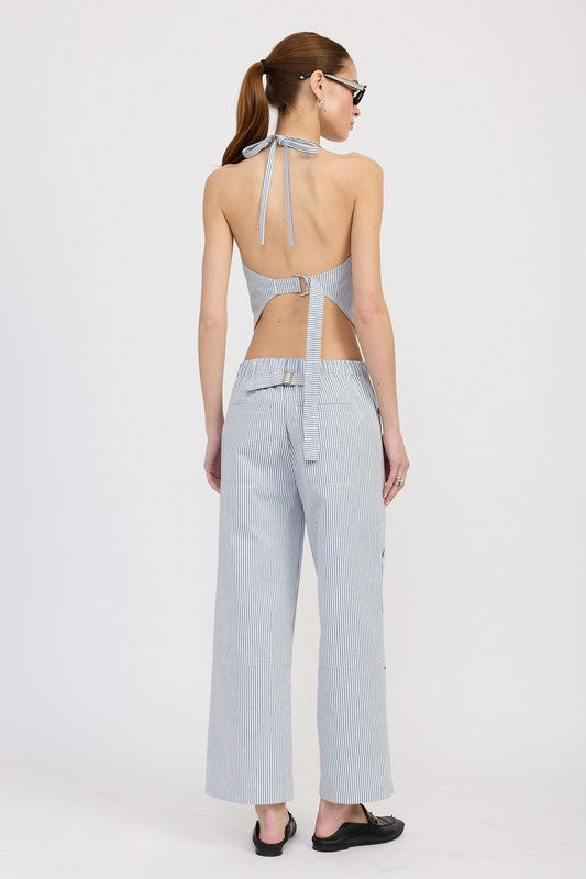 Back view of woman wearing Emory Park Cinched Twill Pants With Wide Leg in light blue with halter top and sunglasses