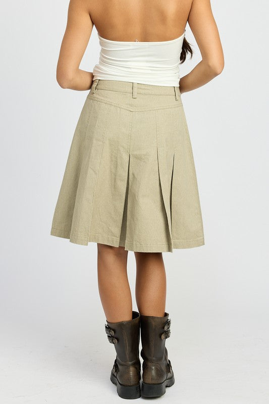 Emory Park knee length pleated skirt in beige worn with white top and brown boots