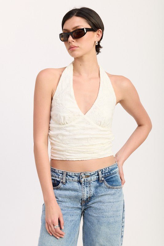 Emory Park Cropped Halter Top With Lace Detail in white worn with blue jeans and sunglasses close up