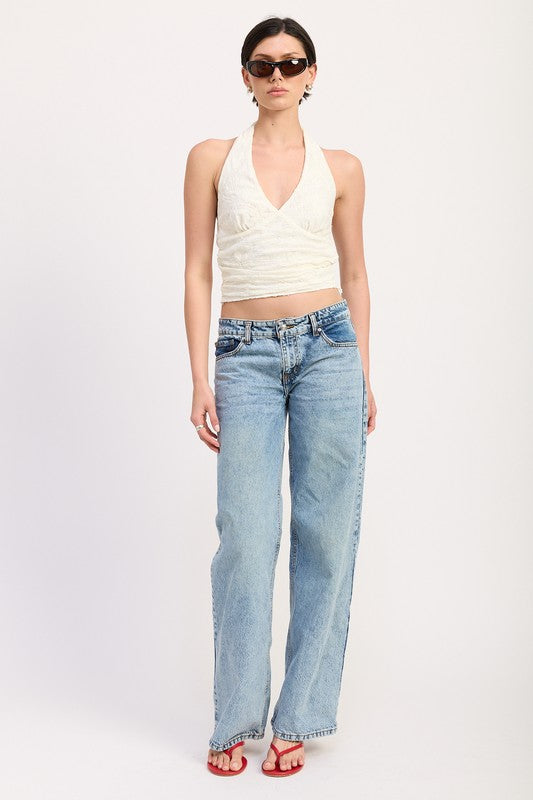 Emory Park Cropped Halter Top With Lace Detail in white paired with light blue jeans and sunglasses