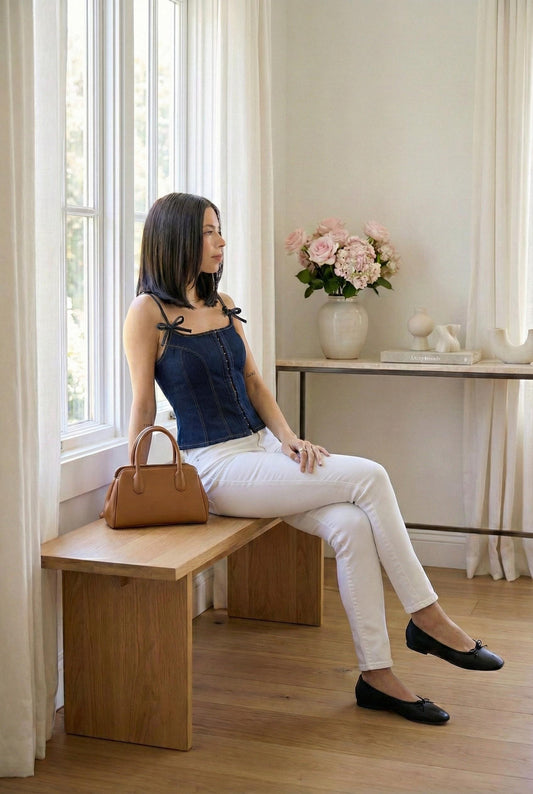 Model wearing Emory Park Denim Bustier Dark Top With Zipper sitting in luxury minimalist home