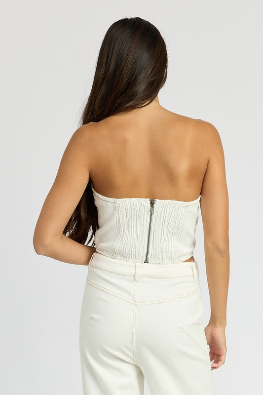 Back view of woman wearing Emory Park Denim Corset Top With Rosette Detail in white with zipper closure