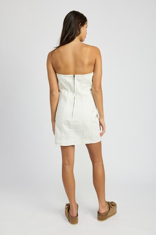 Back view of a woman wearing Emory Park white Denim Tube Dress With Rosette Detail by Emory Park with zipper closure