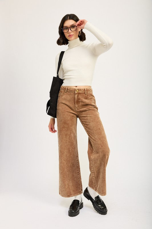 Emory Park Distressed Corduroy Pants in brown on model with cream turtleneck black loafers and bag