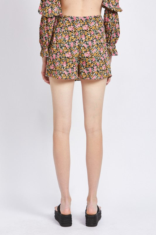 Back view of model wearing Emory Park Ditsy Floral Ruffled Skort with colorful floral print and ruffled details