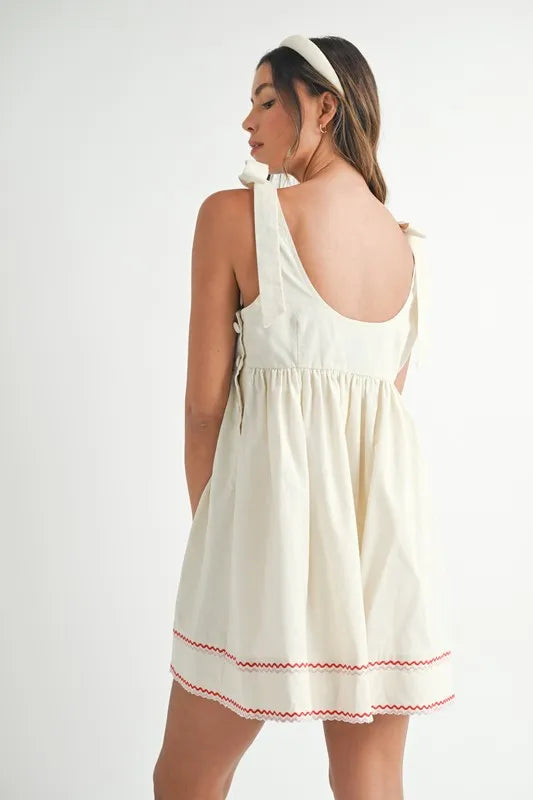Embroidered Mini Dress in cream color with decorative red stitching and adjustable straps