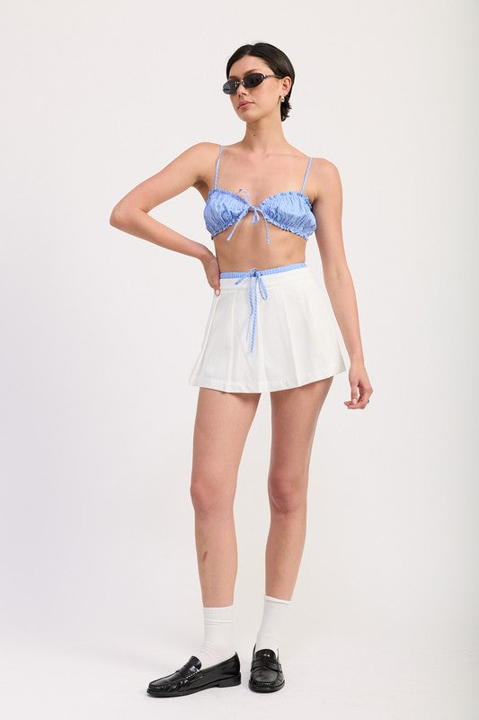 Emory Park Pleated Contrast Trim Skort in white with blue drawstring worn by model with sunglasses
