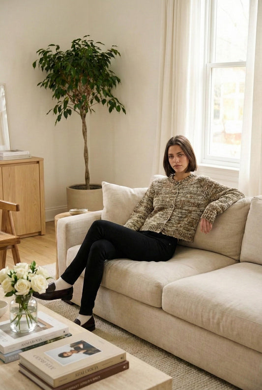 Model wearing Emory Park Fitted Long Sleeve Button Front Cardigan in Taupe Texture for Cozy Layering sitting in luxury minimalist living room