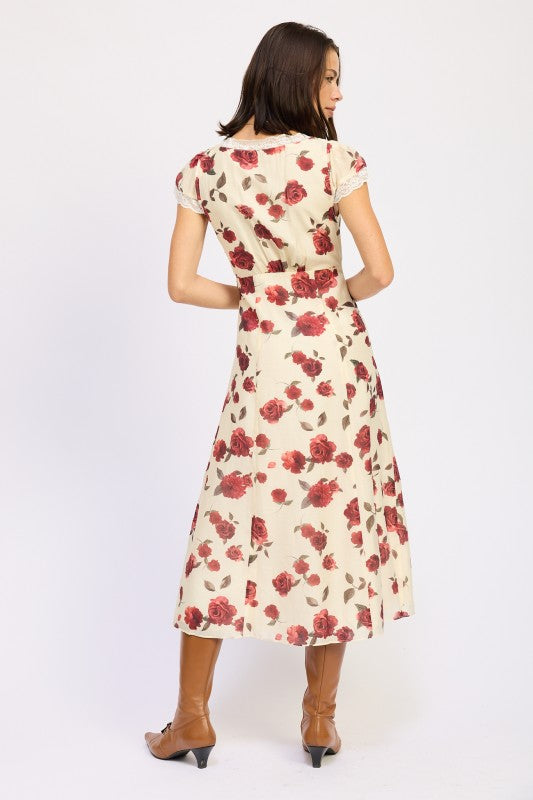 Emory Park model wearing Floral Midi Dress With Lace Detail in cream with red rose print back view and boots