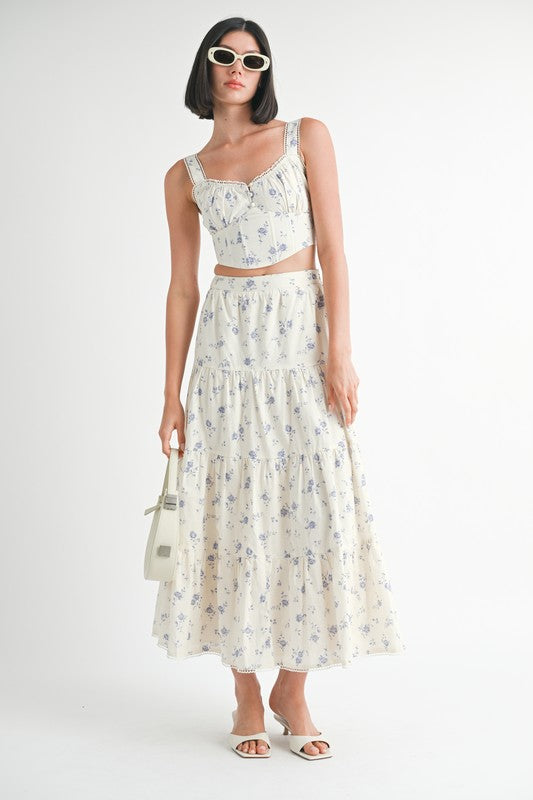 Woman wearing Emory Park Floral Squared Neck Top with matching floral skirt and white accessories
