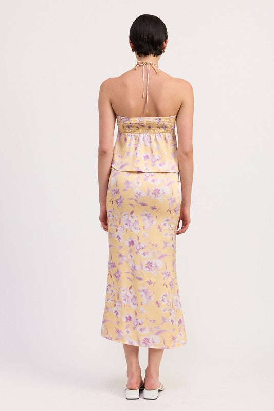 Back view of model wearing Emory Park Floral Strapless Ruched Halter Top in soft yellow with purple floral print