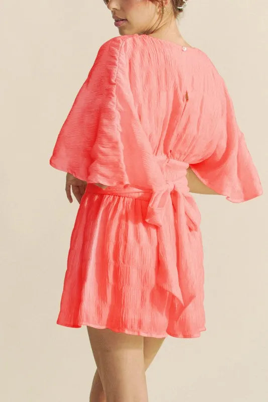 Coral Flutter Sleeve Romper with a Tie Belt and Textured Fabric for a Stylish Summer Look