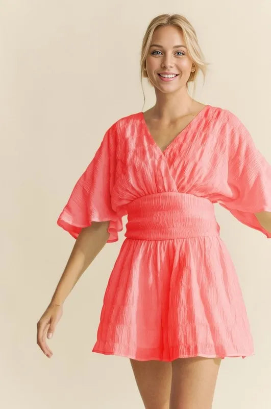 Flutter Sleeve Romper in Bright Coral with a Flattering V-Neck Design