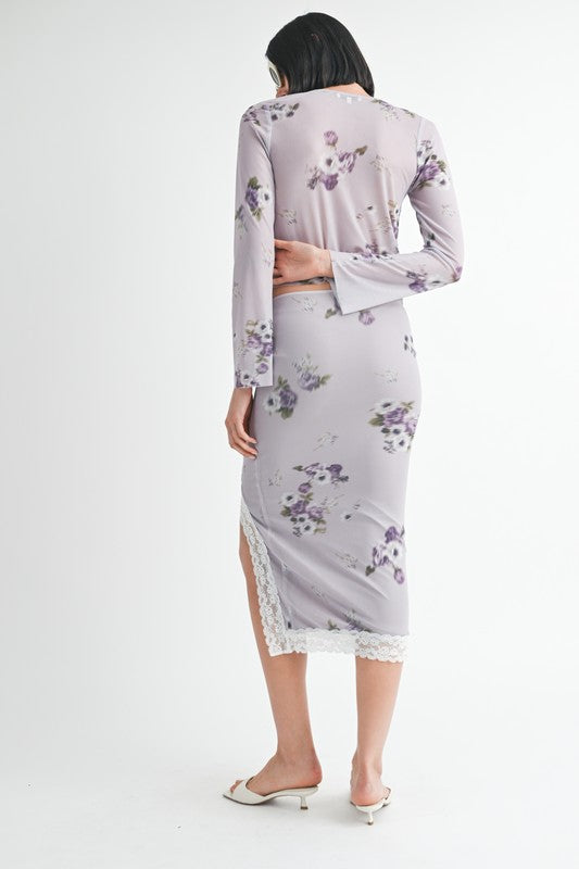 Back view of woman wearing Emory Park Fly Away Floral Top With Lace in soft purple floral print and matching skirt with lace trim
