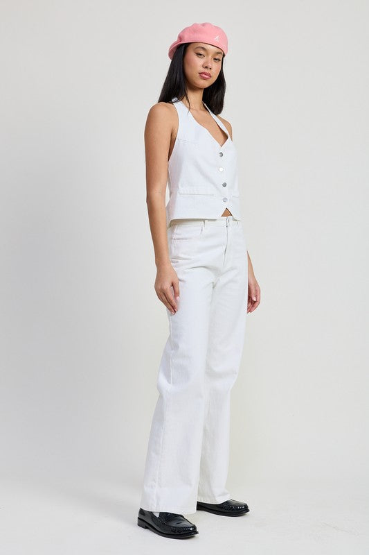 Emory Park white folded fitted denim pants styled with white buttoned vest and pink beret