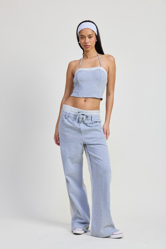 Woman wearing Emory Park halter neck cropped top in light blue with matching wide-leg pants