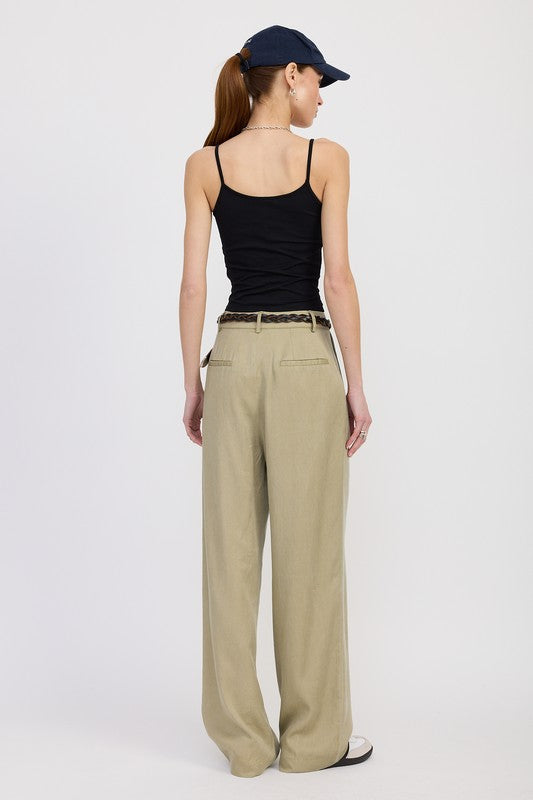 Emory Park high waist wide leg trousers with front pleats in beige worn by a model with black tank top and navy cap