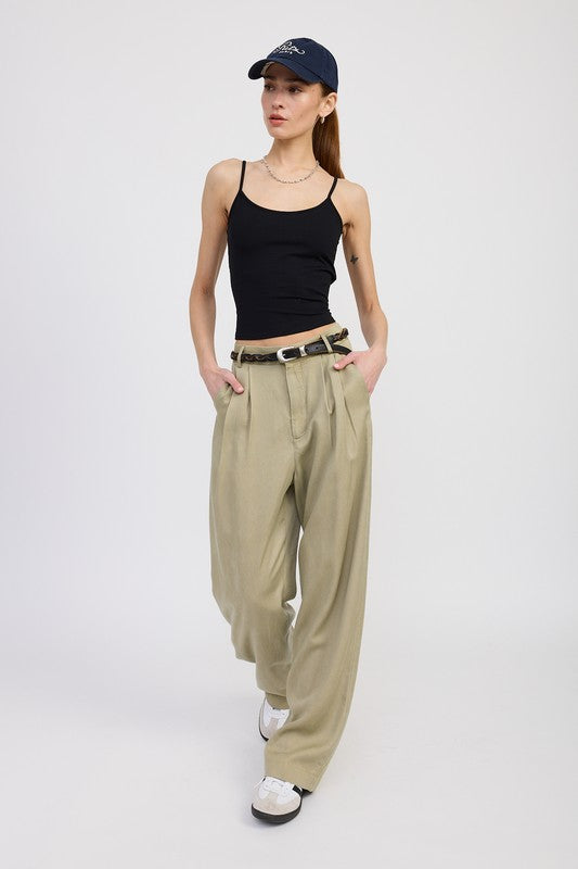 Emory Park high waist wide leg trousers with front pleats in beige worn with black tank top and cap front