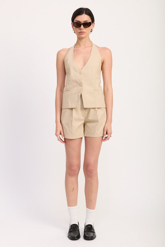 Emory Park high waisted pleated shorts in beige worn with matching vest and black loafers
