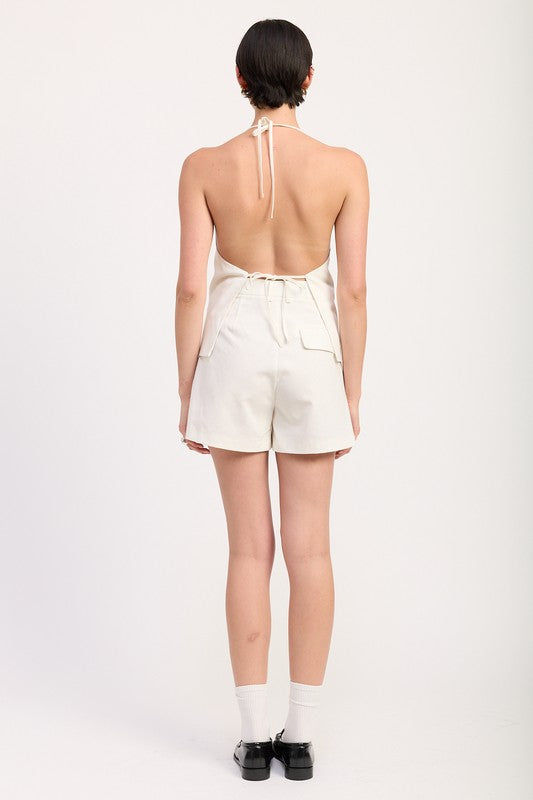 Emory Park white high waisted pleated shorts worn by model from back with halter top