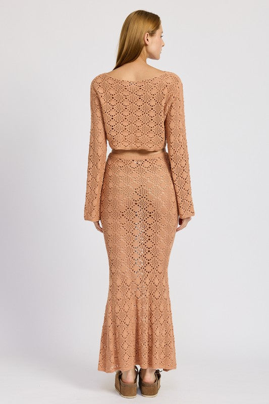 Back view of woman wearing Emory Park Mermaid Maxi Crochet Skirt in tan with matching long sleeve crochet top