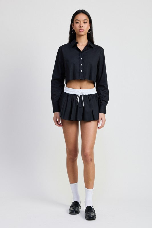 Emory Park Mini Contrast Waistband Skirt in black with white waistband and drawstring worn with black cropped button-up shirt