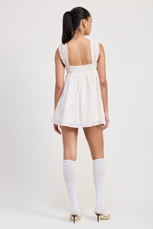 Back view of model wearing Emory Park Mini Floral Babydoll Puff Straps Dress with knee-high white socks and heels