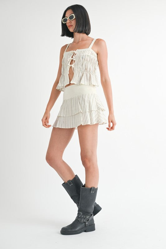 Emory Park model wearing a white Mixed Knit Skort with layered ruffle design and black boots