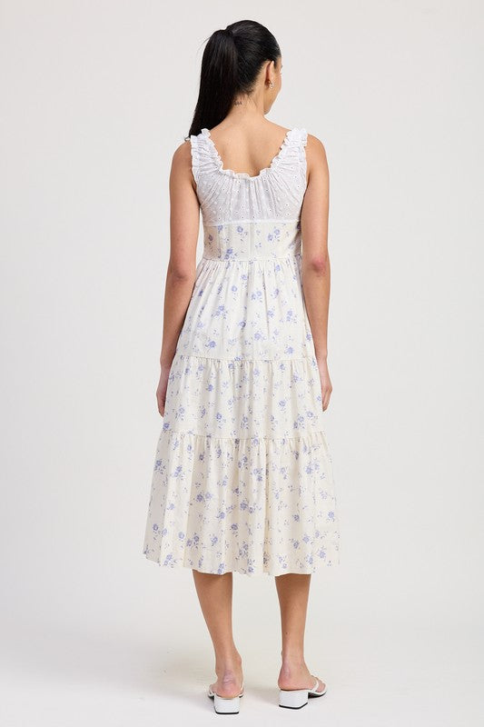 Back view of woman wearing Emory Park Mixed Media Eyelet Peekaboo Midi Dress with floral pattern and ruffle details