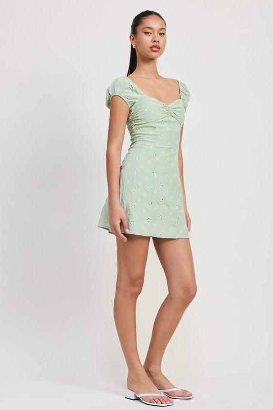 Emory Park Mixed Media Mini Ruched Dress in light green with puff sleeves and floral pattern side pose