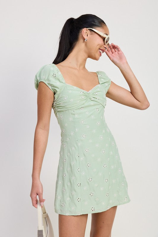 Emory Park Mixed Media Mini Ruched Dress in light green with floral cutout design and puff sleeves