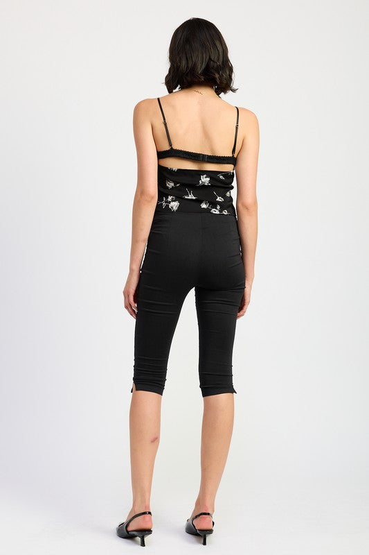 Back view of Emory Park Mixed Media Satin Spaghetti Strap Top worn with black capri pants and heels