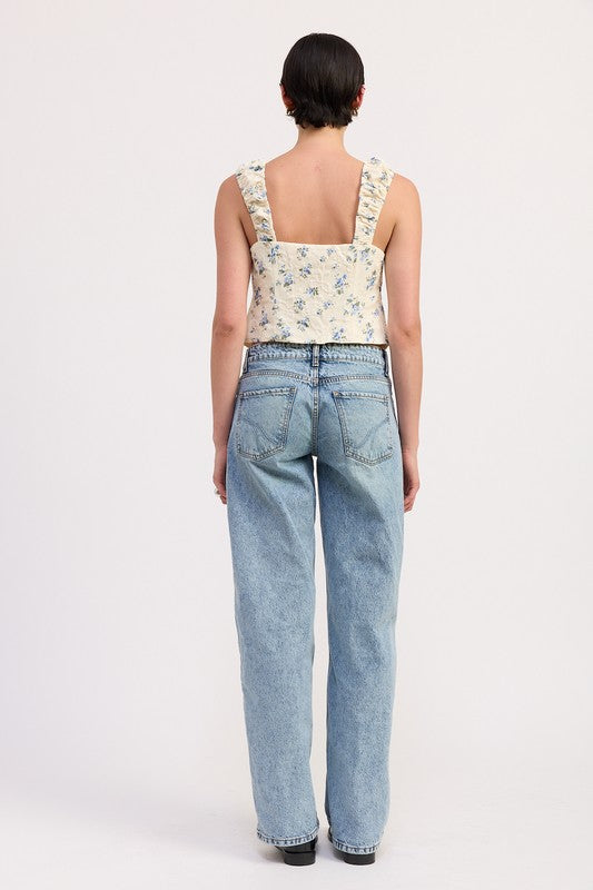 Back view of model wearing Emory Park Tie Front Peasant Top with floral print and wide straps paired with light wash jeans