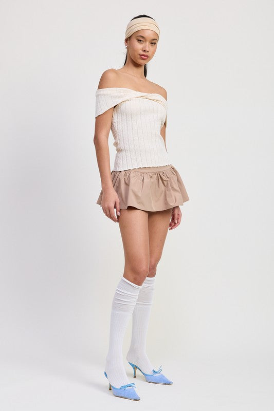 Emory Park off shoulder sweater top in white worn with beige skirt and knee-high white socks