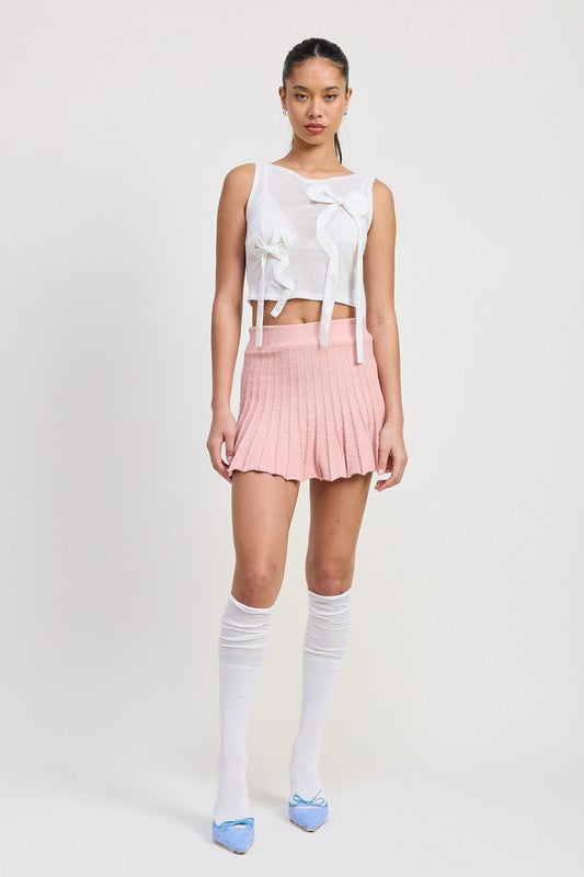 Emory Park pleated mini skirt in soft pink worn with white sleeveless top and knee-high socks